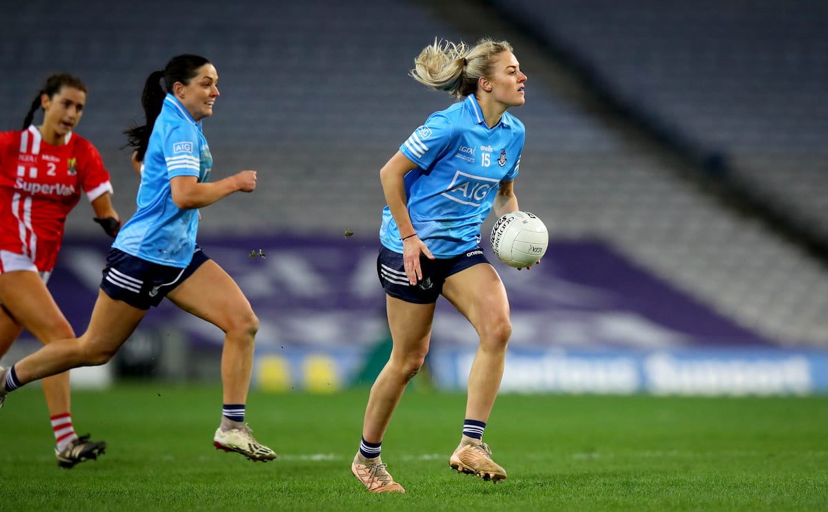 Dublin LGFA player running with ball