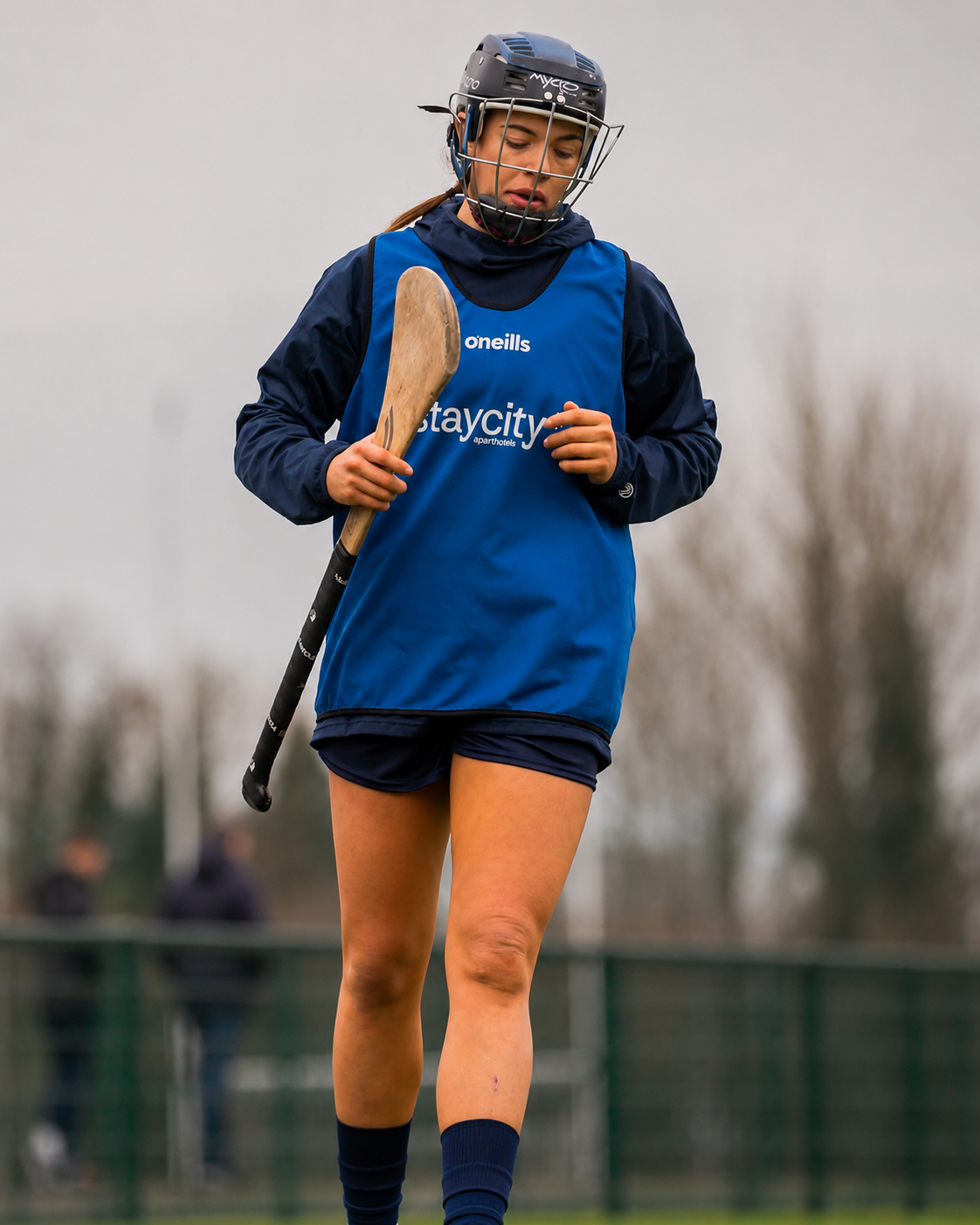 GAA player training in full kit with a hurl